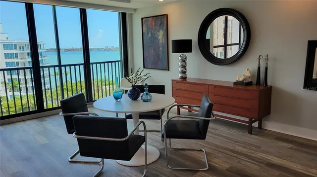 a living room with furniture a mirror and a window