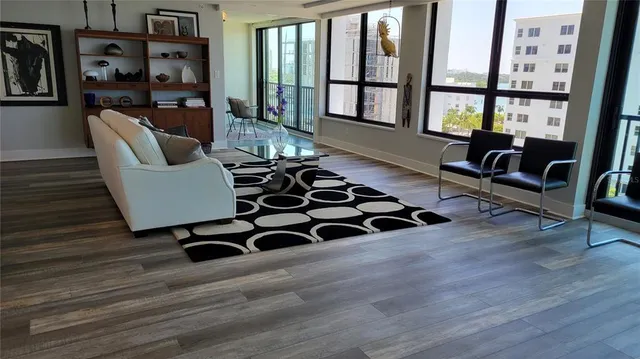 a living room with furniture and a floor to ceiling window