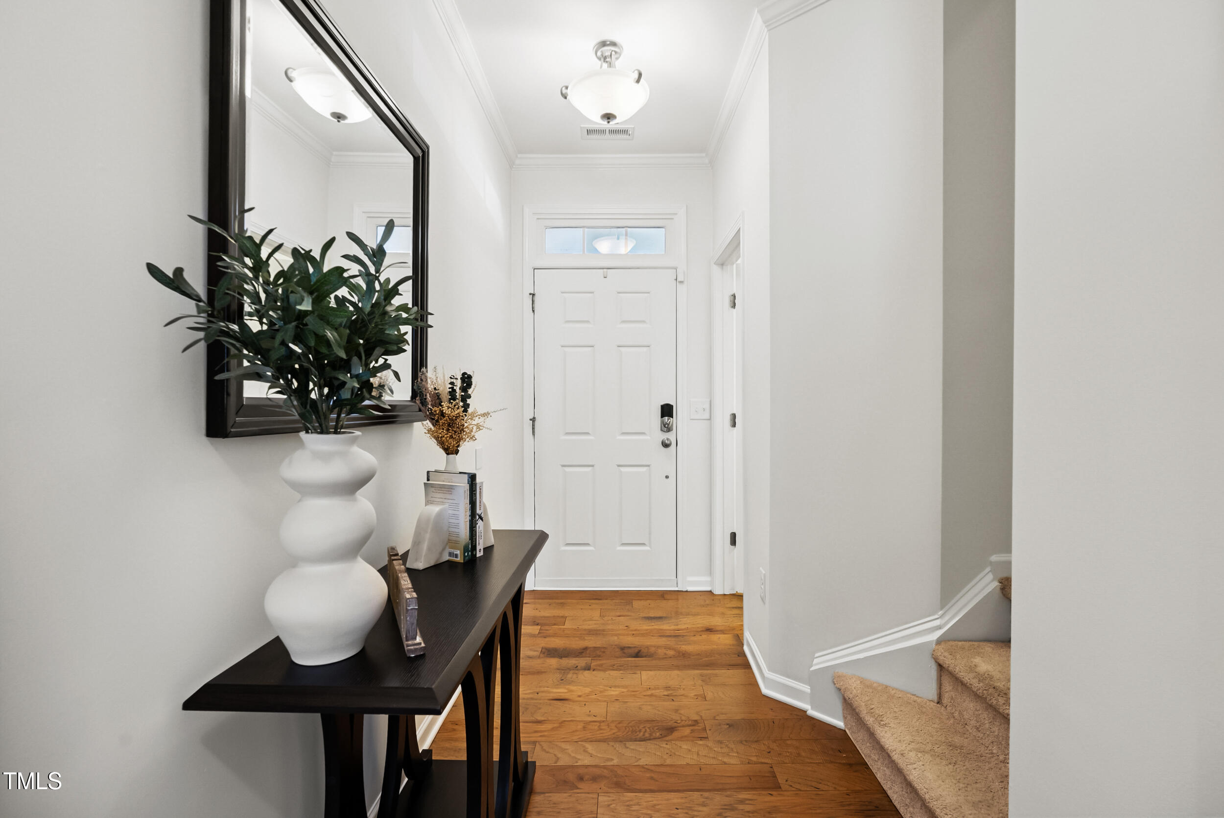 16 Daly Court Durham, NC 27705 - Photo 4 of 35 a view of a hallway with table and front door