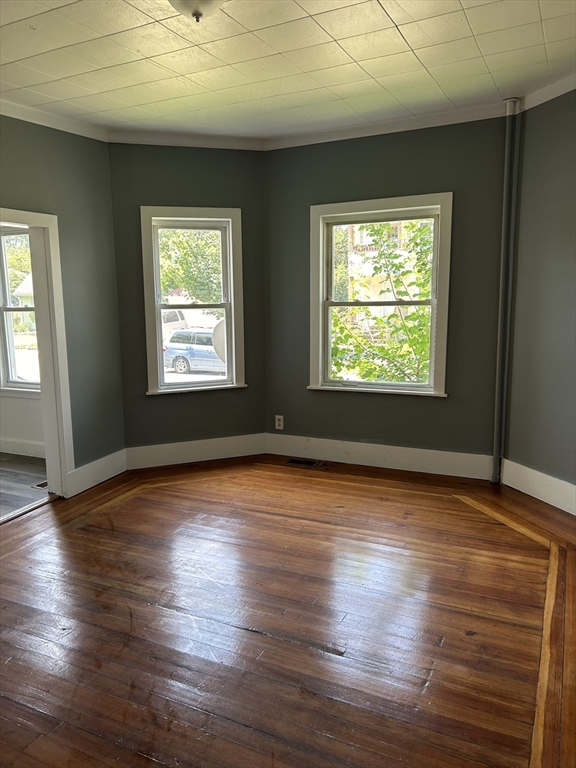 385 Orange Street Springfield, MA 01108 - Photo 11 of 11 a view of an empty room with wooden floor and a window