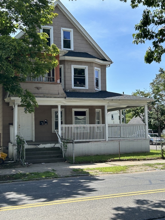 385 Orange Street Springfield, MA 01108 - Photo 2 of 11 a front view of a house with a garden
