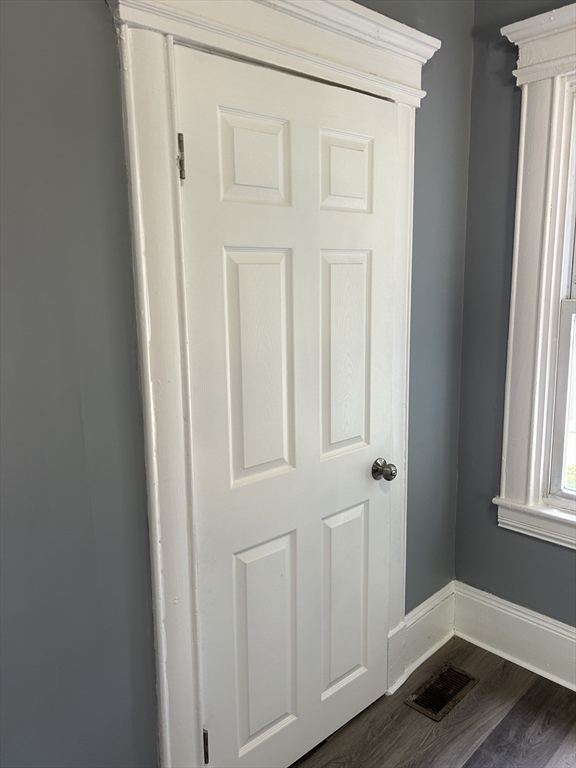 385 Orange Street Springfield, MA 01108 - Photo 8 of 11 an entryway with wooden floor and cabinet