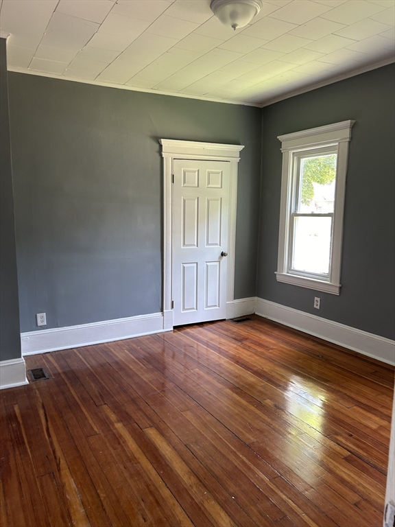 385 Orange Street Springfield, MA 01108 - Photo 10 of 11 an empty room with wooden floor and windows