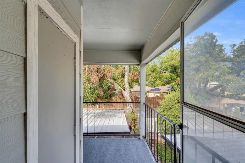 a view of a room with wooden floor and windows