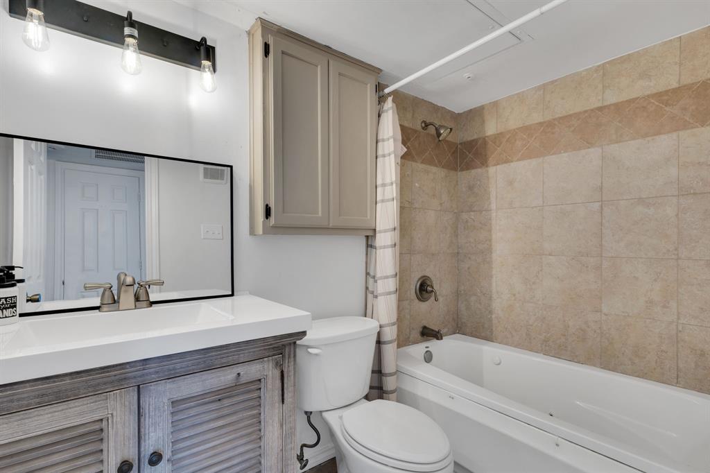 3206 South Fielder Road, Unit 209 Arlington, TX 76015 - Photo 13 of 22 a bathroom with a sink a toilet a mirror and shower