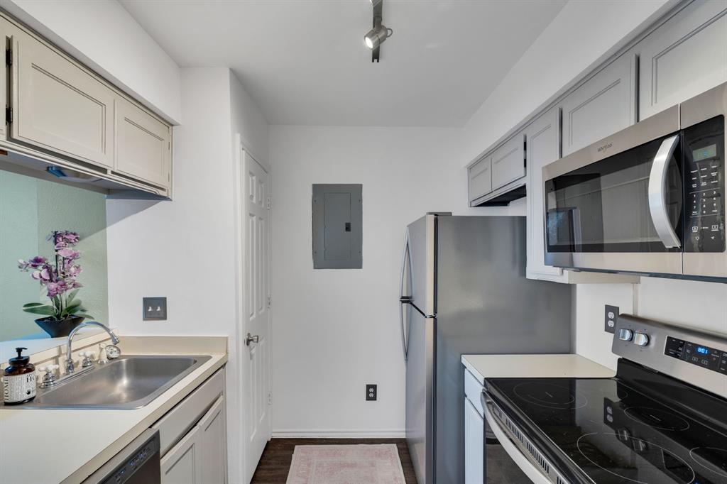 3206 South Fielder Road, Unit 209 Arlington, TX 76015 - Photo 18 of 22 a kitchen with stainless steel appliances granite countertop a sink stove and refrigerator