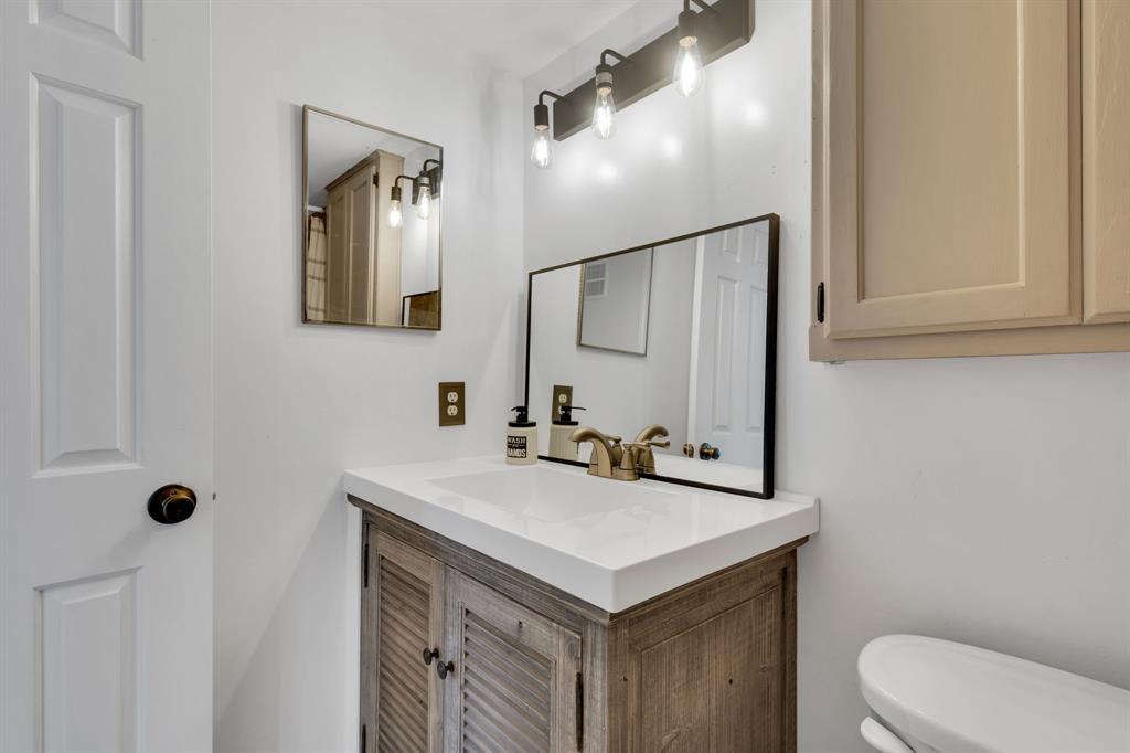 3206 South Fielder Road, Unit 209 Arlington, TX 76015 - Photo 19 of 22 a bathroom with a sink toilet and mirror