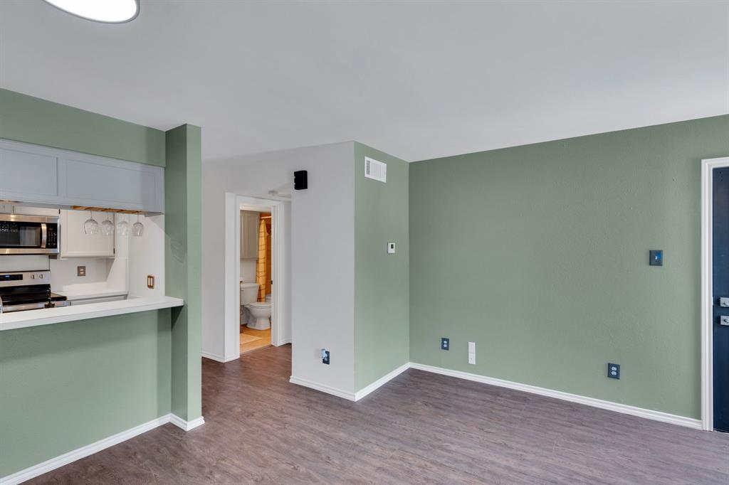 3206 South Fielder Road, Unit 209 Arlington, TX 76015 - Photo 8 of 22 a view of a kitchen with wooden floor and electronic appliances