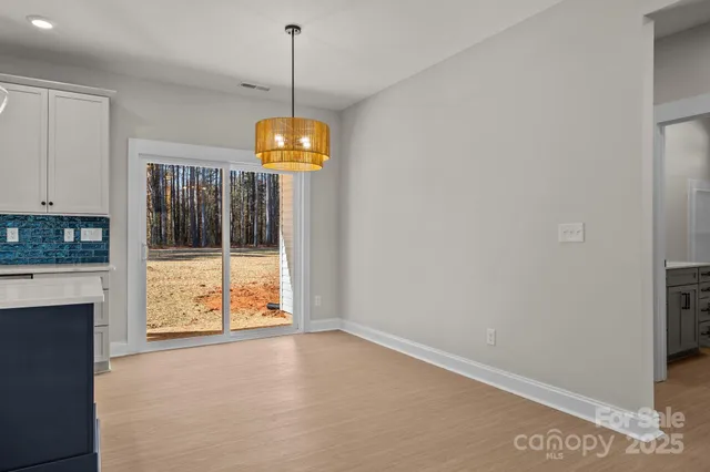 a view of an empty room with a fireplace and a window