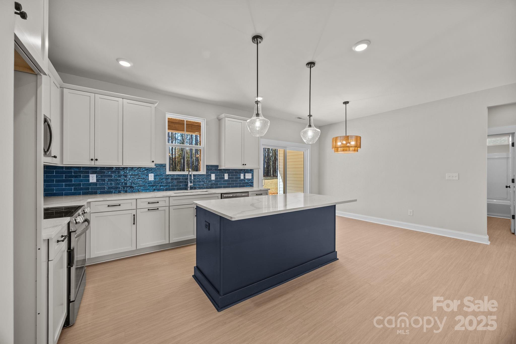 2295 Lee Lawing Road Lincolnton, NC 28092 - Photo 17 of 46 a kitchen with granite countertop a sink and a stove top oven