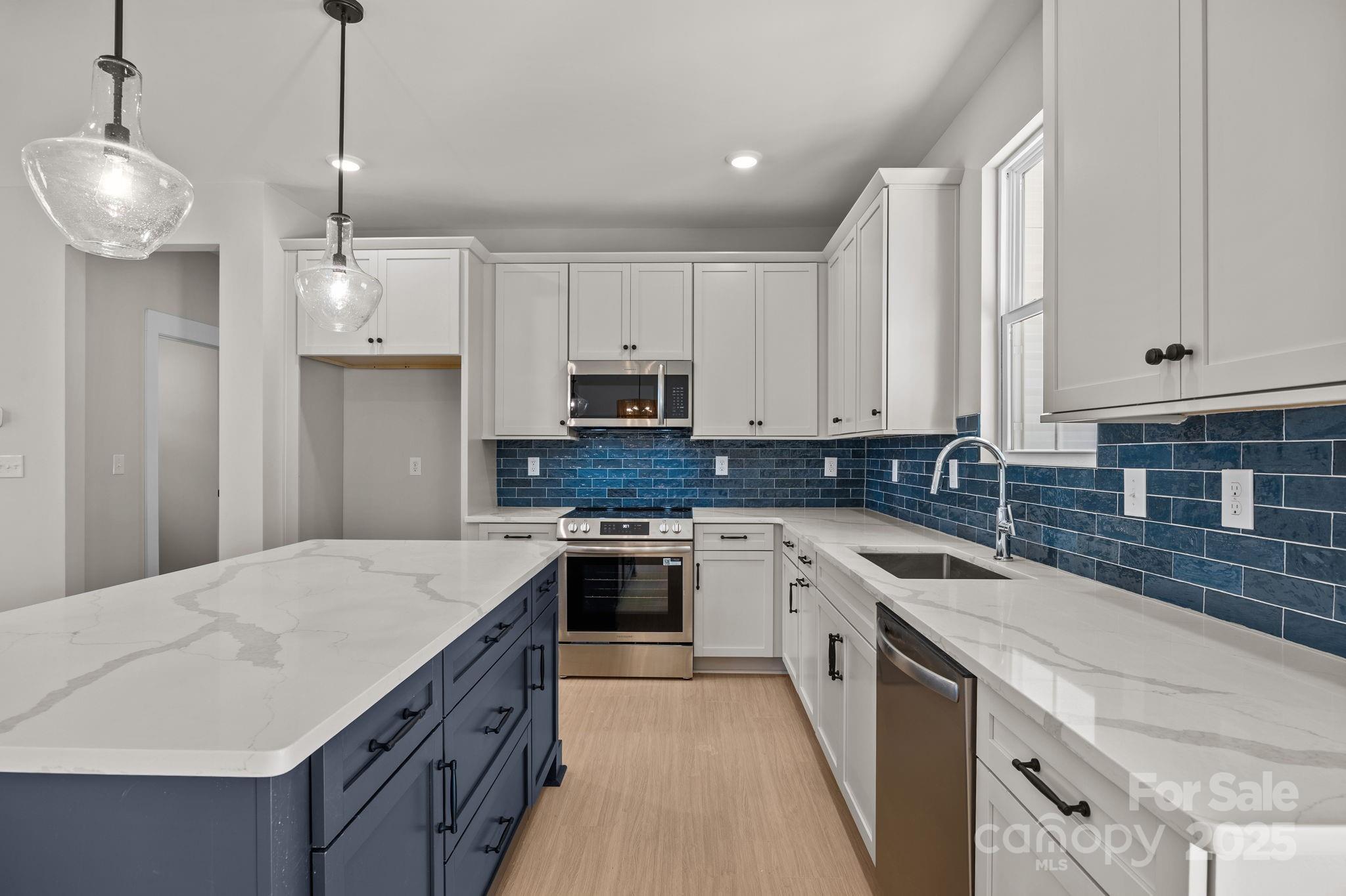 2295 Lee Lawing Road Lincolnton, NC 28092 - Photo 18 of 46 a kitchen with a sink stove and white cabinets