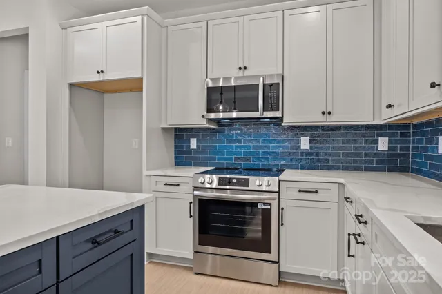 a kitchen with cabinets appliances and a sink
