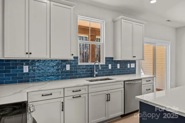 a kitchen with granite countertop white cabinets and white appliances