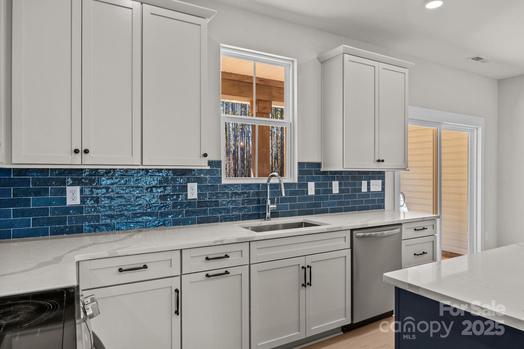 2295 Lee Lawing Road Lincolnton, NC 28092 - Photo 21 of 46 a kitchen with granite countertop white cabinets and white appliances