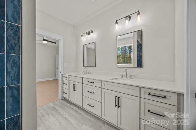 a bathroom with a double vanity sink and mirror