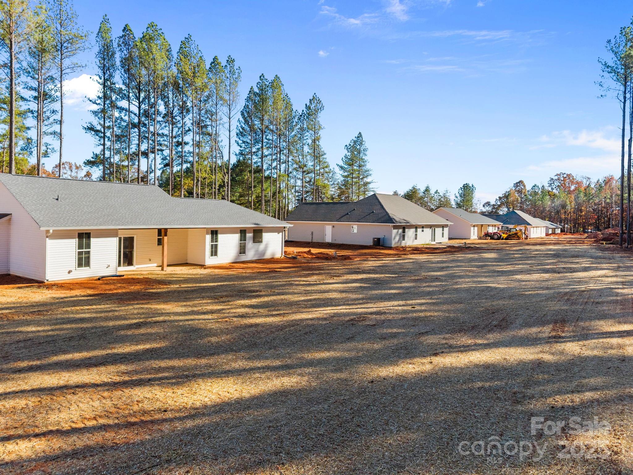 2295 Lee Lawing Road Lincolnton, NC 28092 - Photo 39 of 46 a view of a house next to a road with large trees