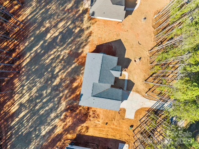 an aerial view of residential houses with outdoor space and ocean view