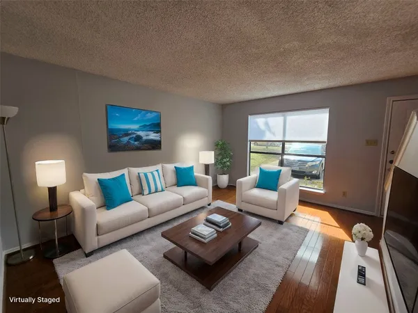a living room with furniture a rug a window and a lamp