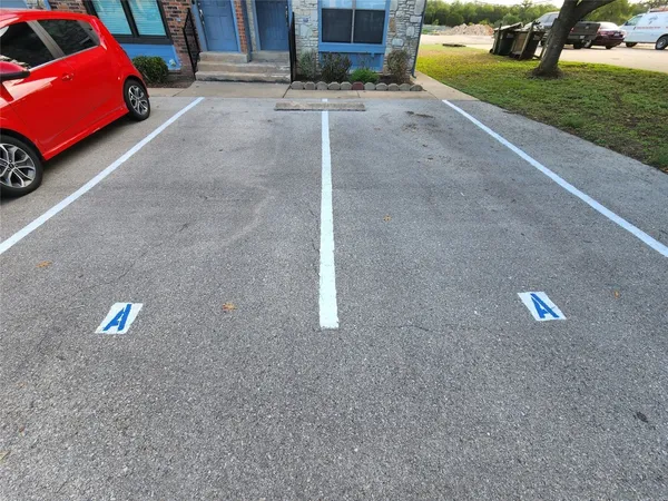a view of a street with a cars parked side of road