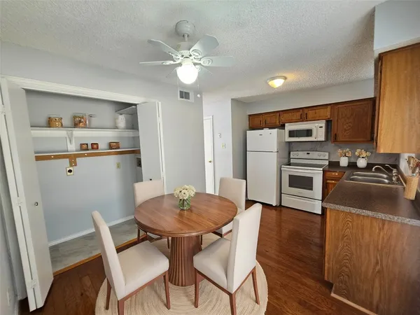 a view of kitchen with cabinets and wooden floor