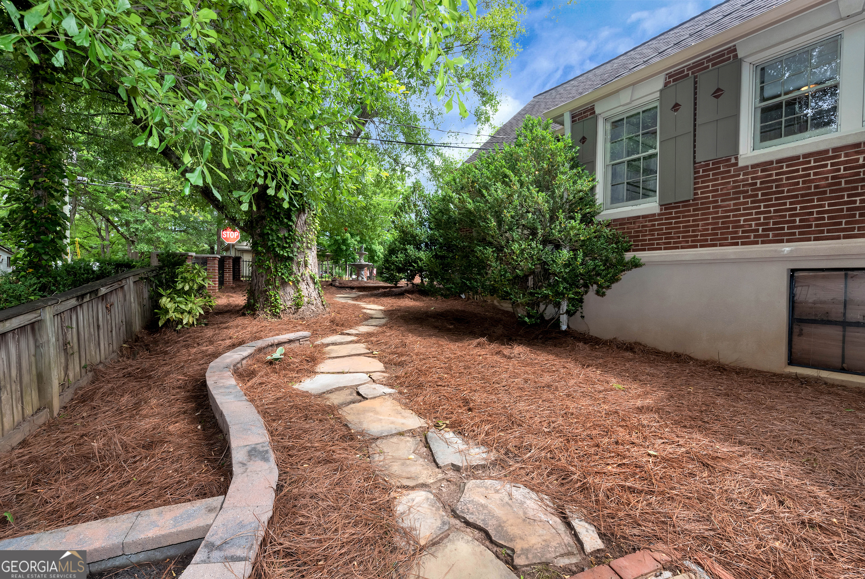 952 Wayside Street Northwest Cornelia, GA 30531 - Photo 57 of 70 a view of a backyard with large trees and wooden fence