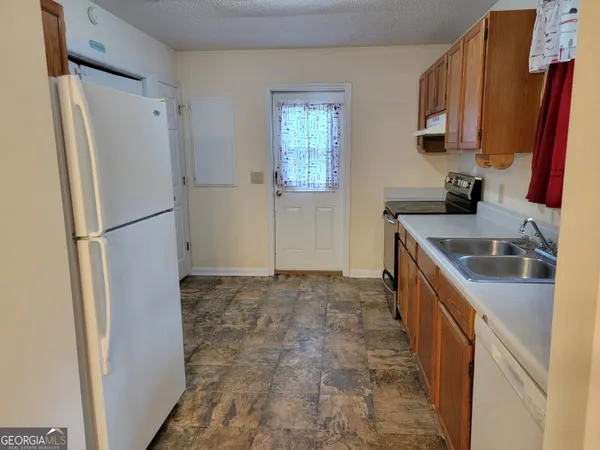 a kitchen with a refrigerator sink and stove