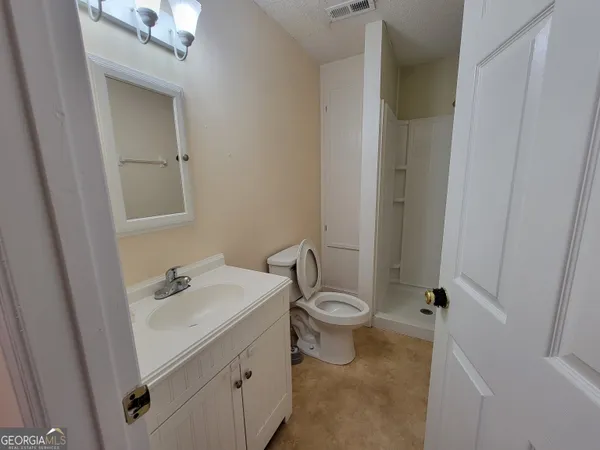 a bathroom with a sink toilet and vanity