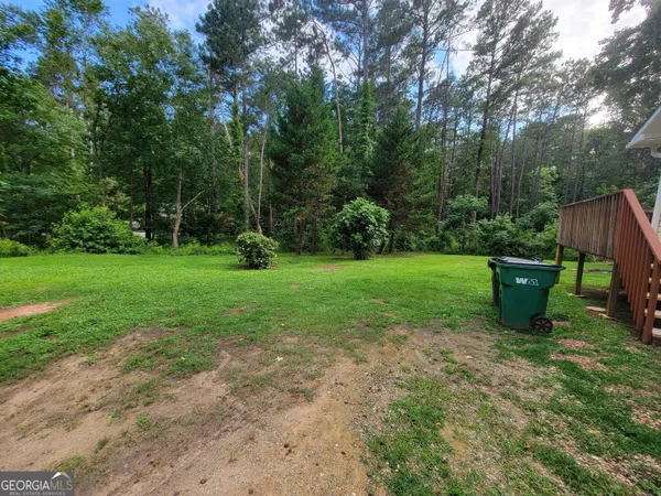a view of a backyard with sitting area