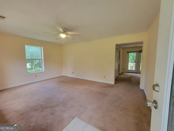 an empty room with windows and closet