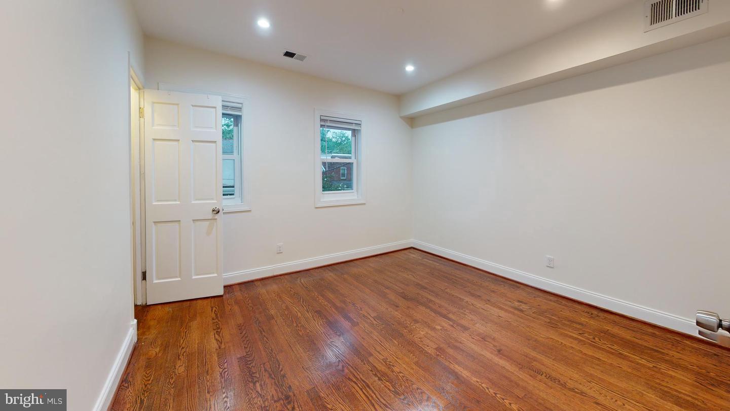 1622 Ridge Place Southeast Washington, DC 20020 - Photo 11 of 27 an empty room with wooden floor and windows