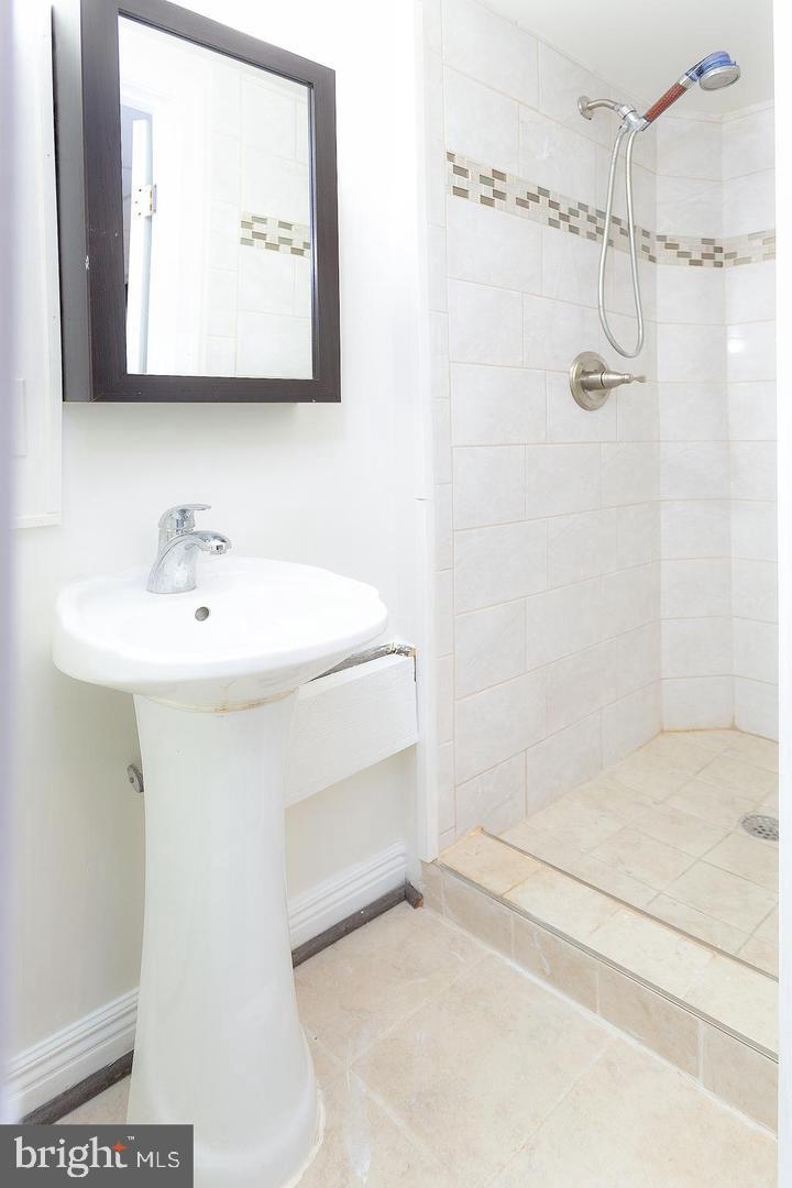 1622 Ridge Place Southeast Washington, DC 20020 - Photo 15 of 27 a bathroom with a sink a mirror and shower