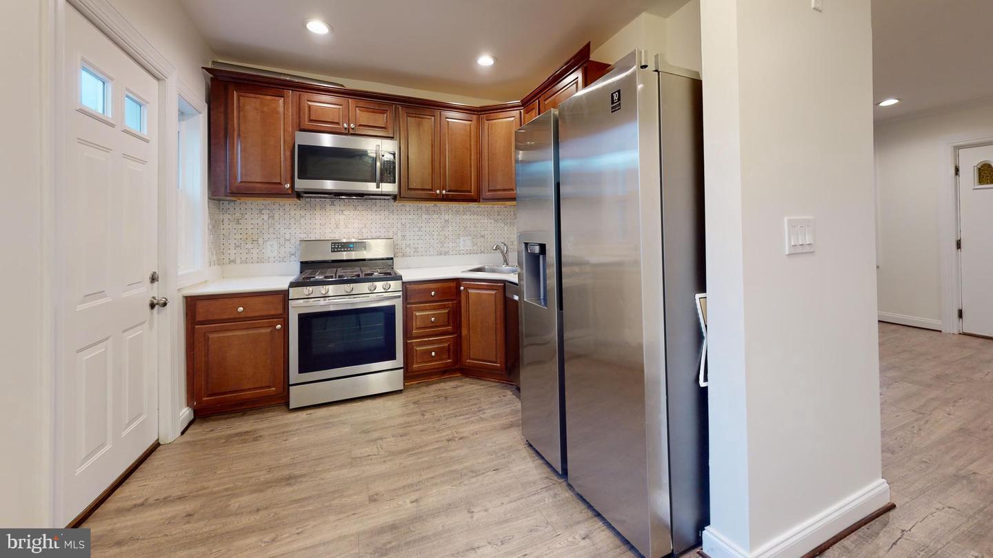 1622 Ridge Place Southeast Washington, DC 20020 - Photo 3 of 27 a kitchen with stainless steel appliances granite countertop a refrigerator a stove a sink and a microwave