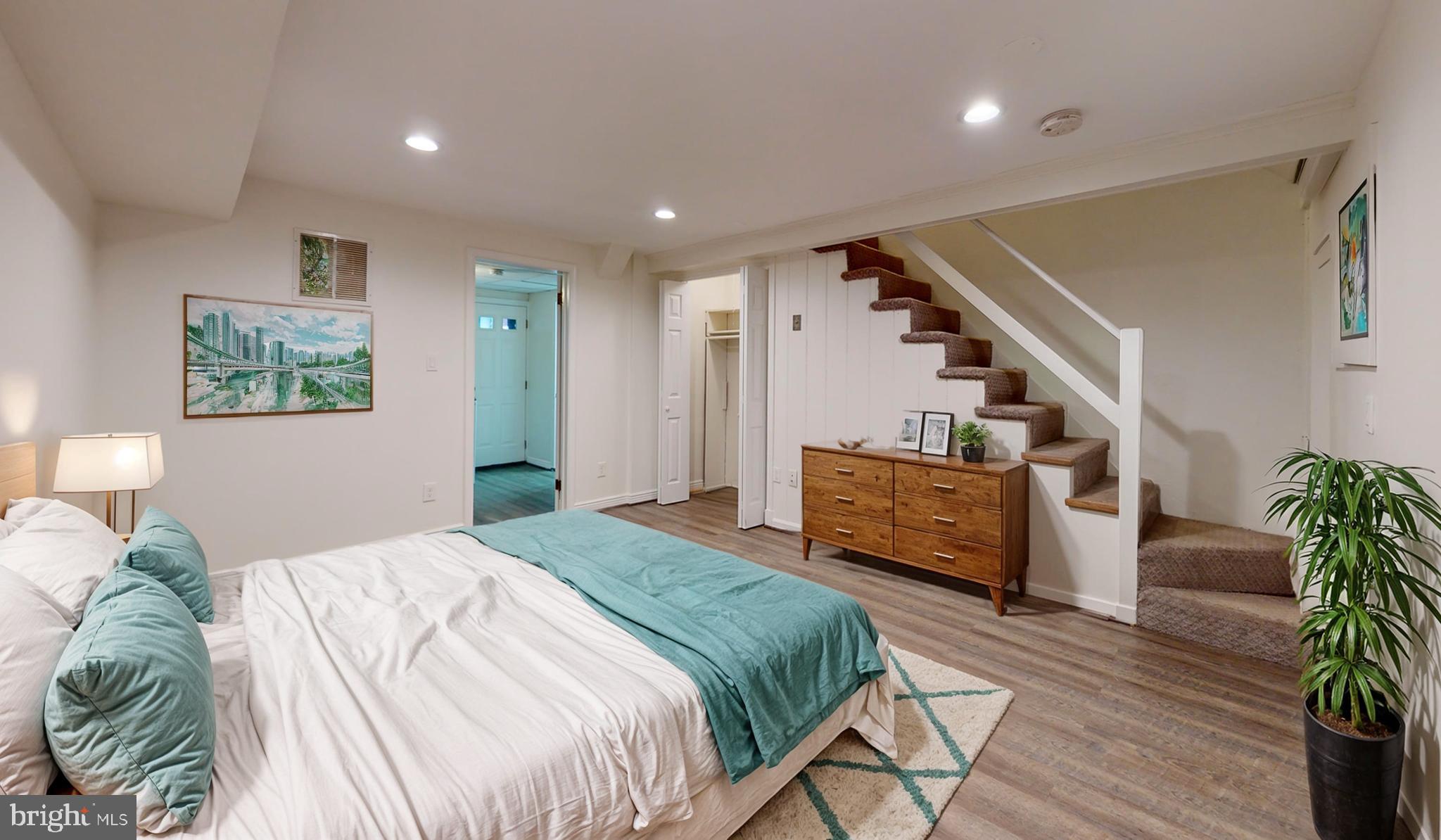 1622 Ridge Place Southeast Washington, DC 20020 - Photo 6 of 27 a bedroom with a bed and a wooden floor