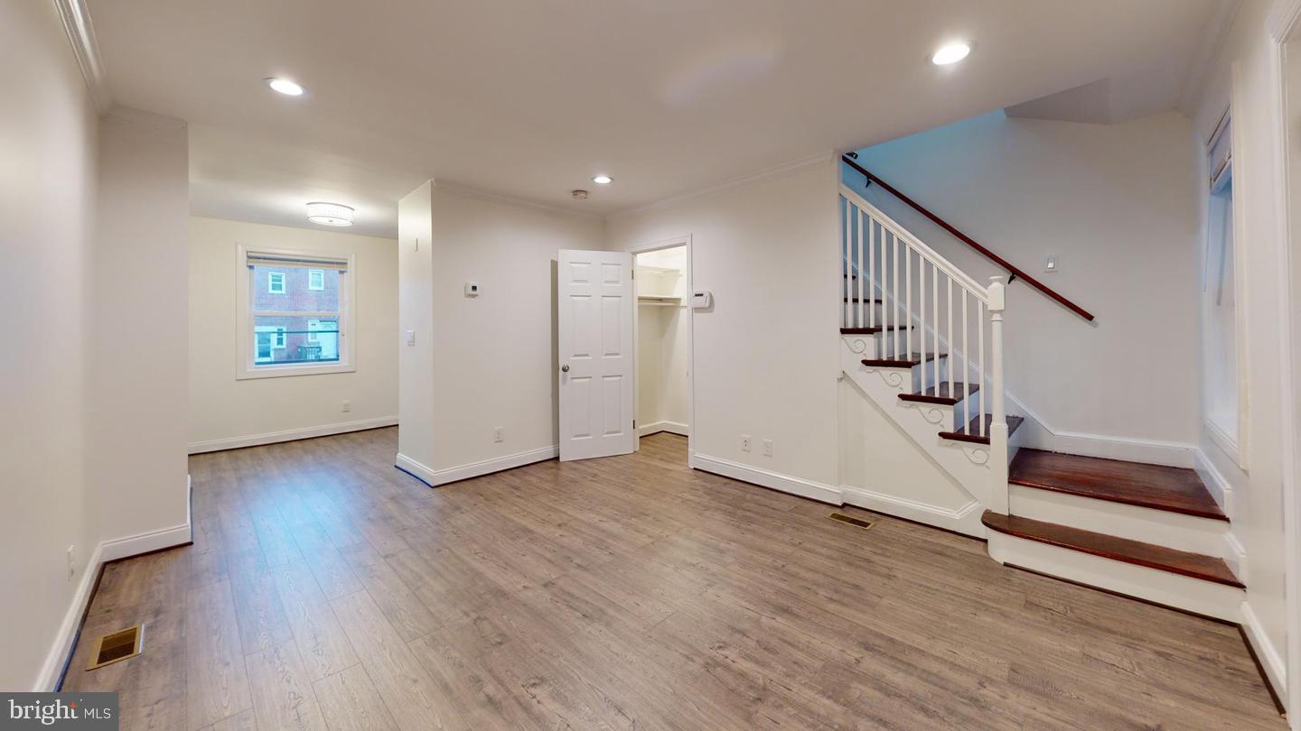 1622 Ridge Place Southeast Washington, DC 20020 - Photo 7 of 27 wooden floor in an empty room with a window