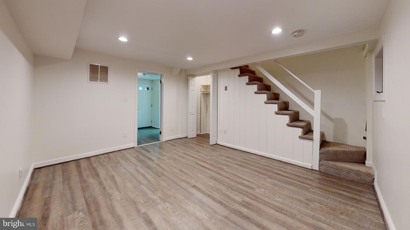 1622 Ridge Place Southeast Washington, DC 20020 - Photo 8 of 27 a view of an empty room with wooden floor and stairs