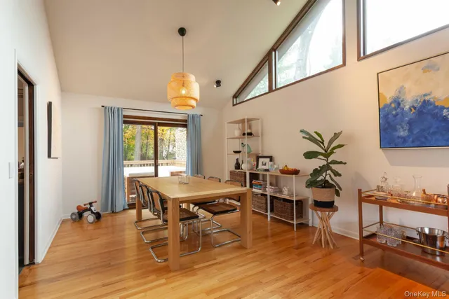 a view of a dining room with furniture window and wooden floor
