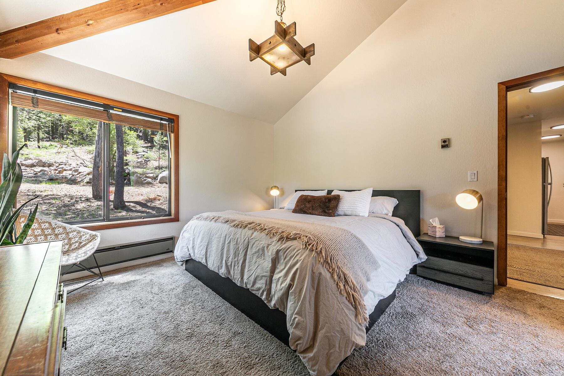 3003 Meadow Court, Unit 5 Olympic Valley, CA 96146 - Photo 12 of 28 a spacious bedroom with a bed and a large window