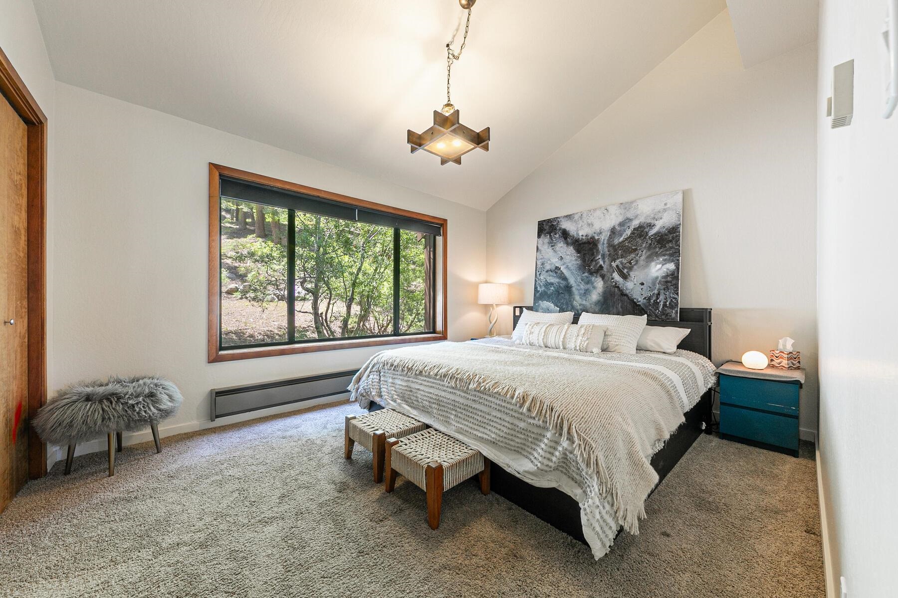 3003 Meadow Court, Unit 5 Olympic Valley, CA 96146 - Photo 14 of 28 a spacious bedroom with a bed and a chandelier