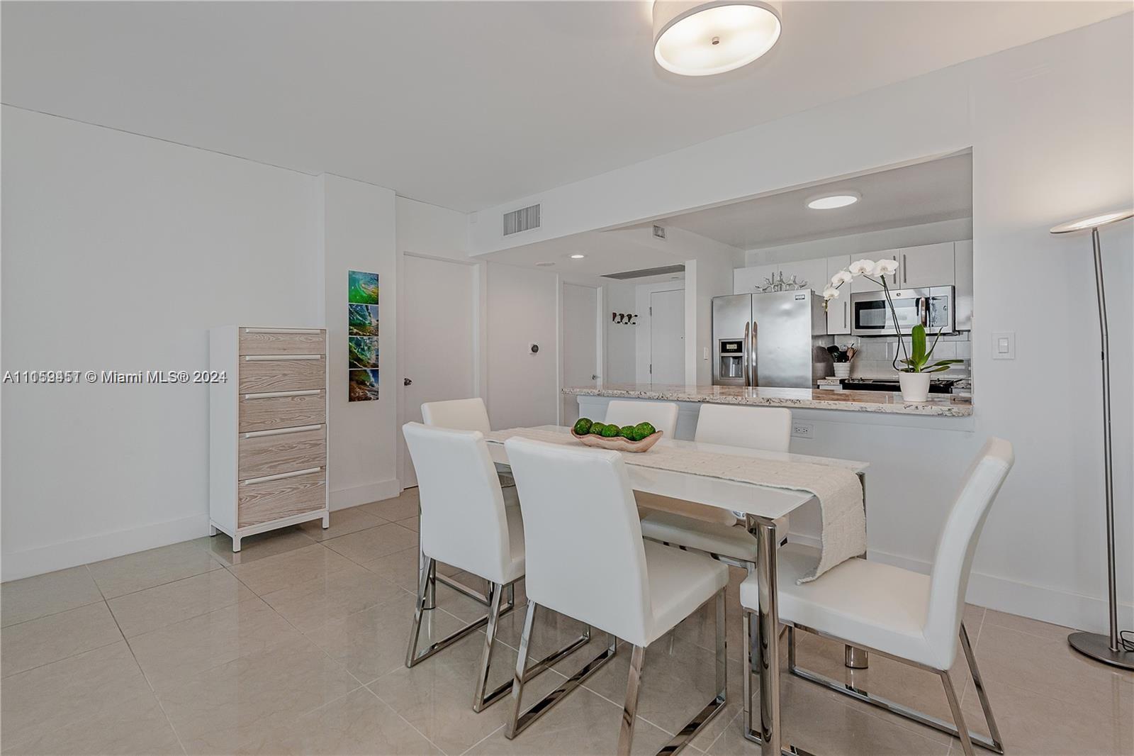 2301 Collins Avenue, Unit 938 Miami Beach, FL 33139 - Photo 20 of 47 a dining room with furniture and window