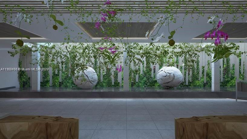 2301 Collins Avenue, Unit 938 Miami Beach, FL 33139 - Photo 39 of 47 a backyard of a house with lots of green space and a fountain