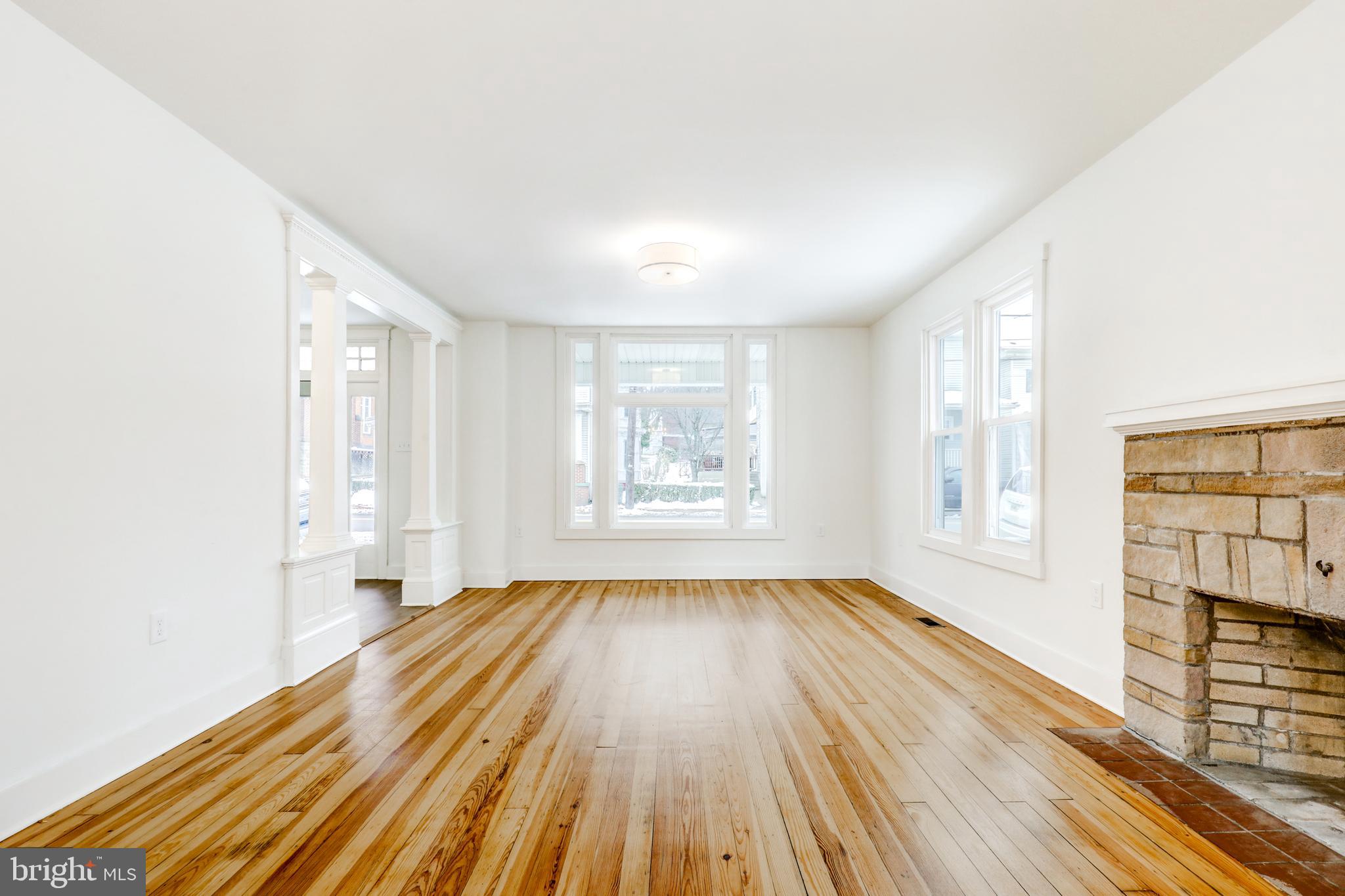 711 Main Street Lykens, PA 17048 - Photo 11 of 38 an empty room with wooden floor and windows