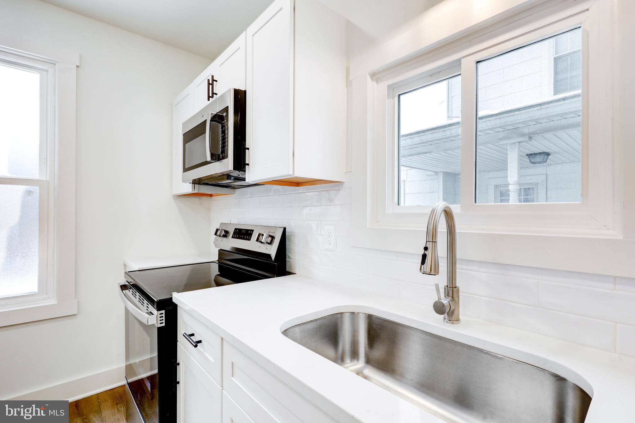711 Main Street Lykens, PA 17048 - Photo 14 of 38 a kitchen with stainless steel appliances a sink a stove and microwave