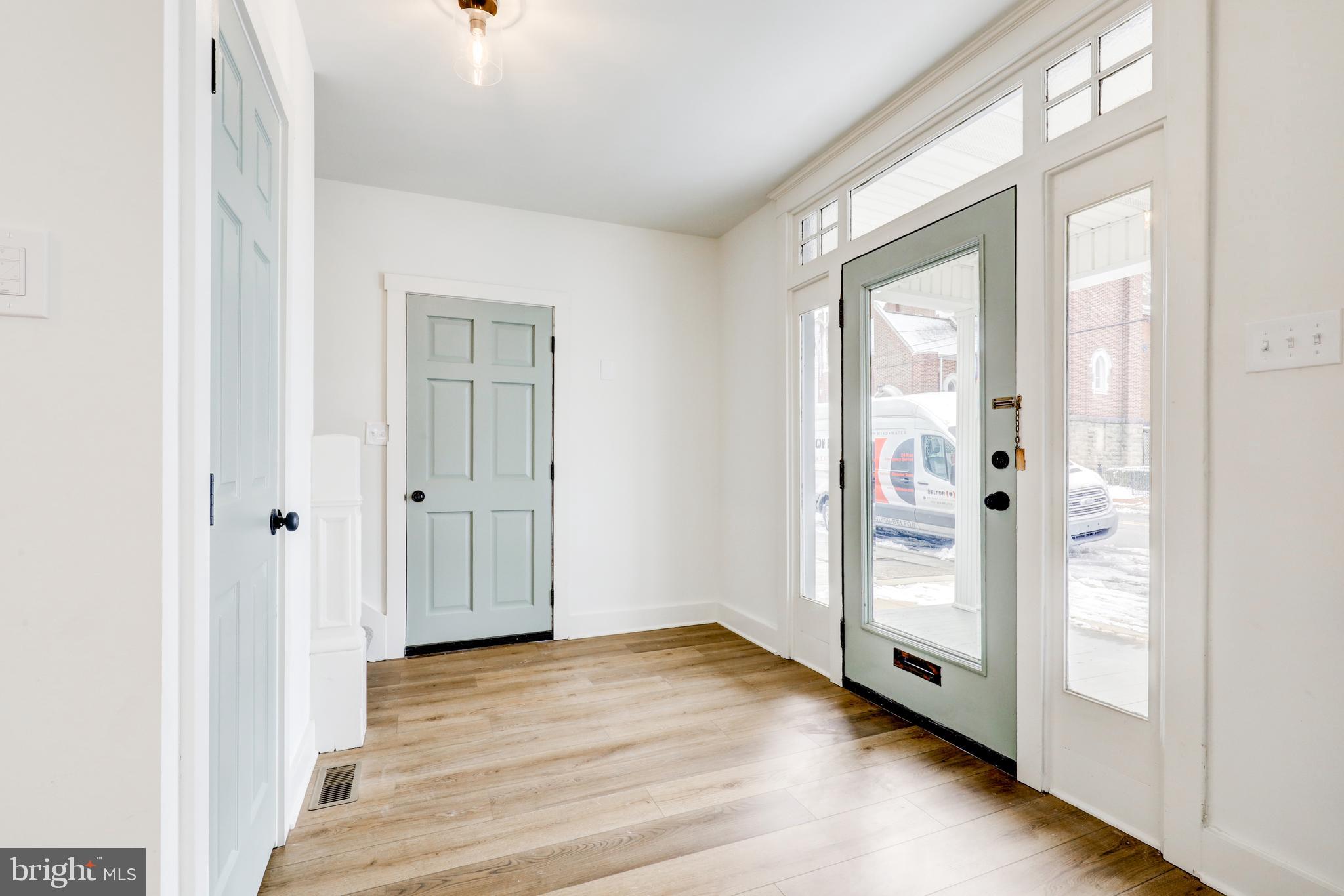 711 Main Street Lykens, PA 17048 - Photo 3 of 38 an empty room with wooden floor and windows