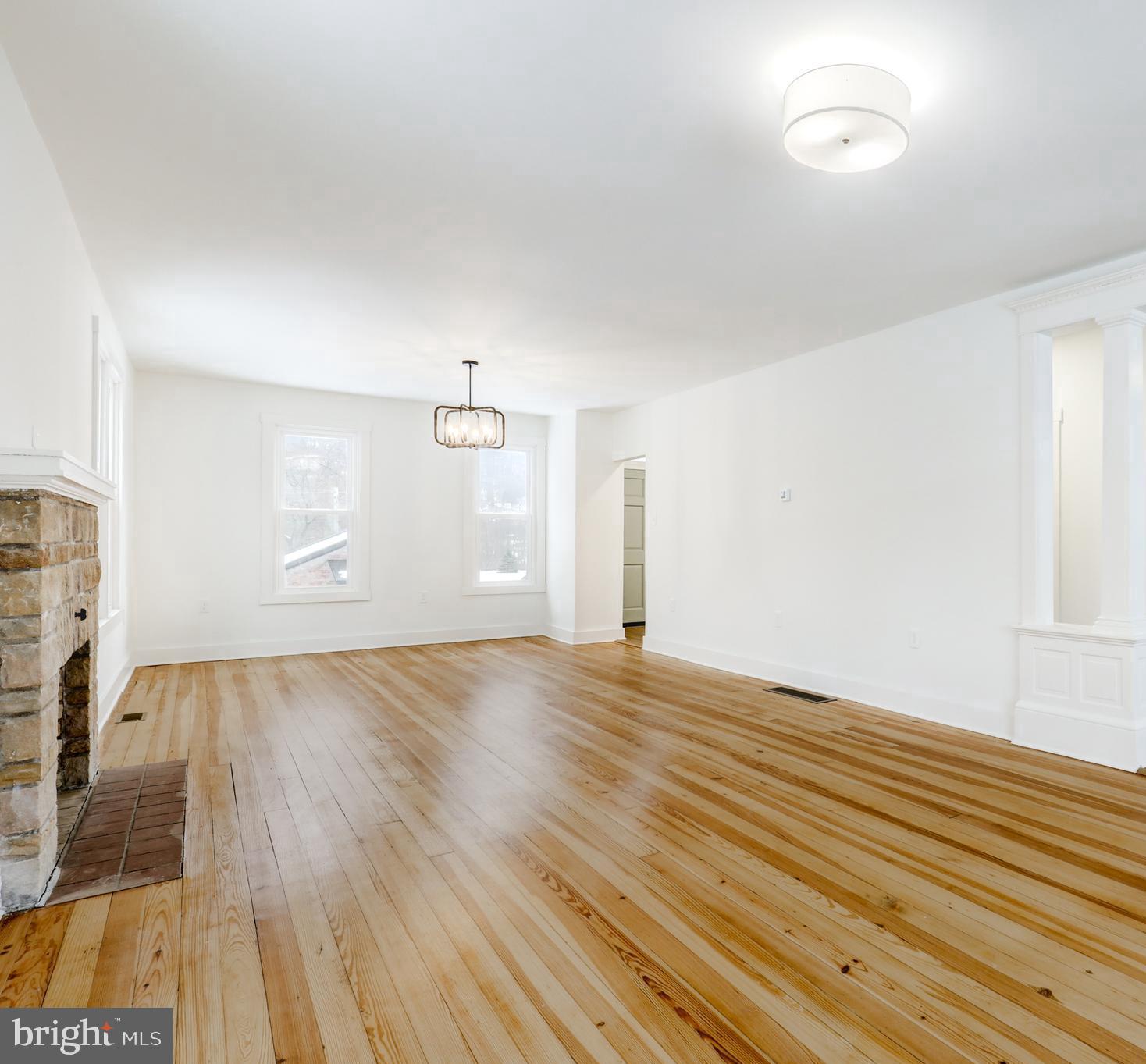 711 Main Street Lykens, PA 17048 - Photo 8 of 38 an empty room with wooden floor and windows