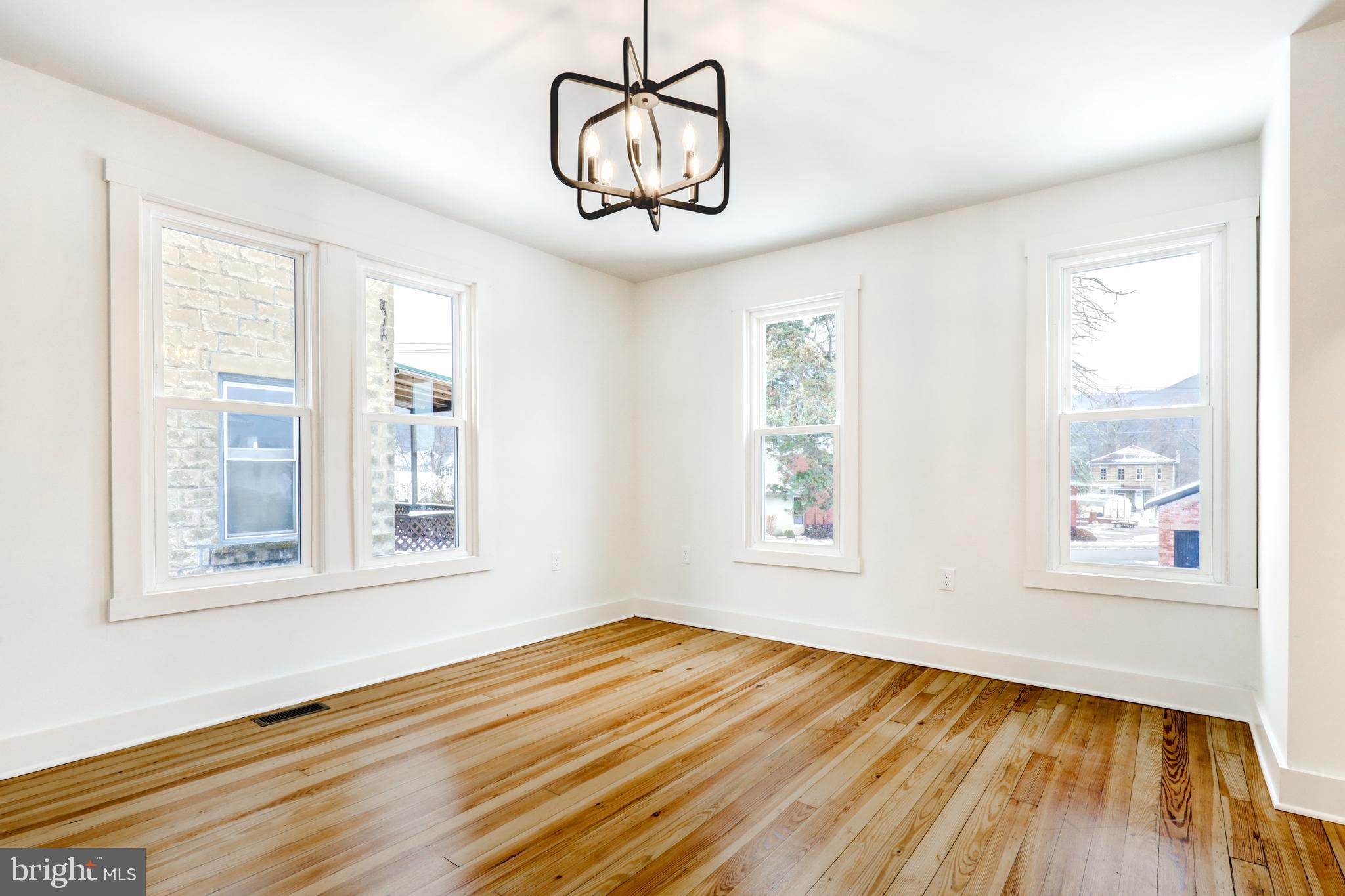711 Main Street Lykens, PA 17048 - Photo 10 of 38 a view of empty room with wooden floor and fan