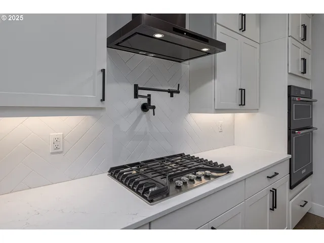 a kitchen with granite countertop a stove and cabinets
