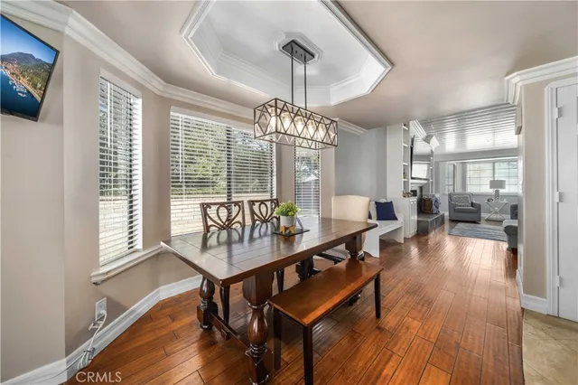 a dining room with furniture window and wooden floor