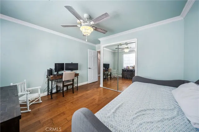 a bedroom with furniture and a wooden floor