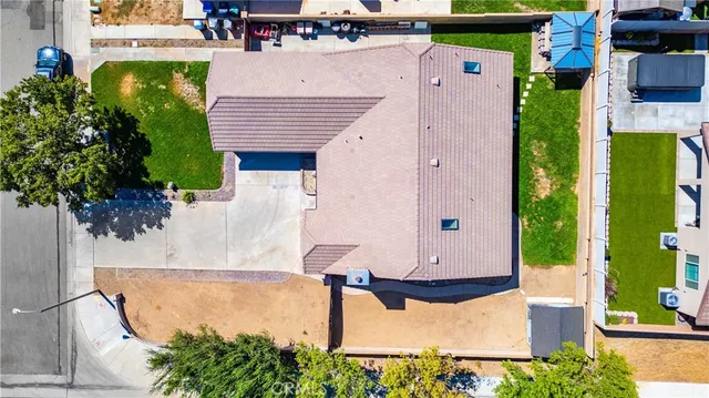 an aerial view of a house with a garden and swimming pool