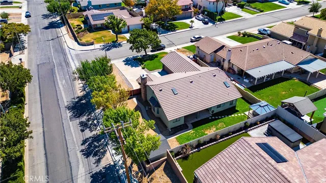 an aerial view of a house with a garden and swimming pool